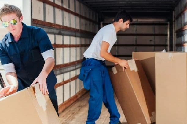 Movers loading boxes into a moving truck
